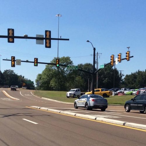 An intersection as seen from the sidewalk.