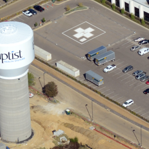 An aerial view of a water tower surrounded by a parking lot. The water tower says, "Baptist Medical Center."