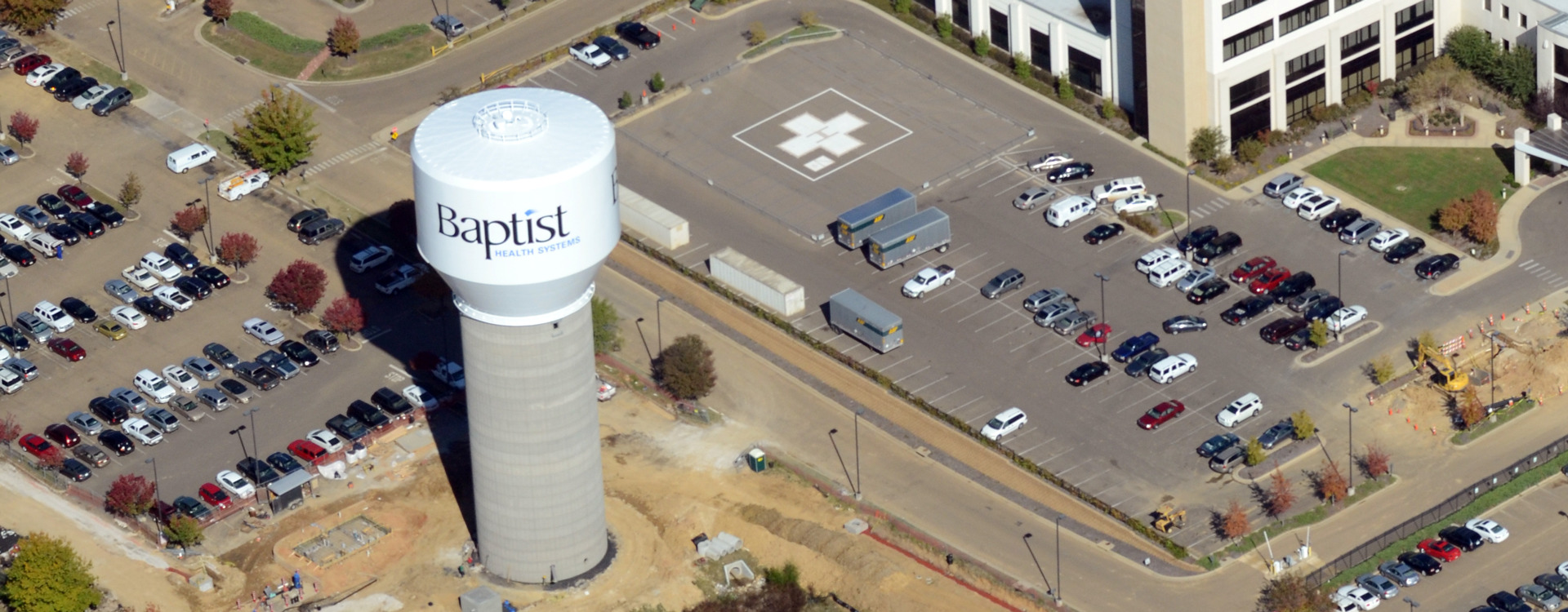 An aerial view of a water tower surrounded by a parking lot. The water tower says, "Baptist Medical Center."