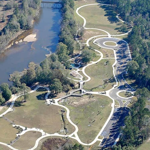 An aerial view of the park. It's an open grassy area with concrete walkways throughout.