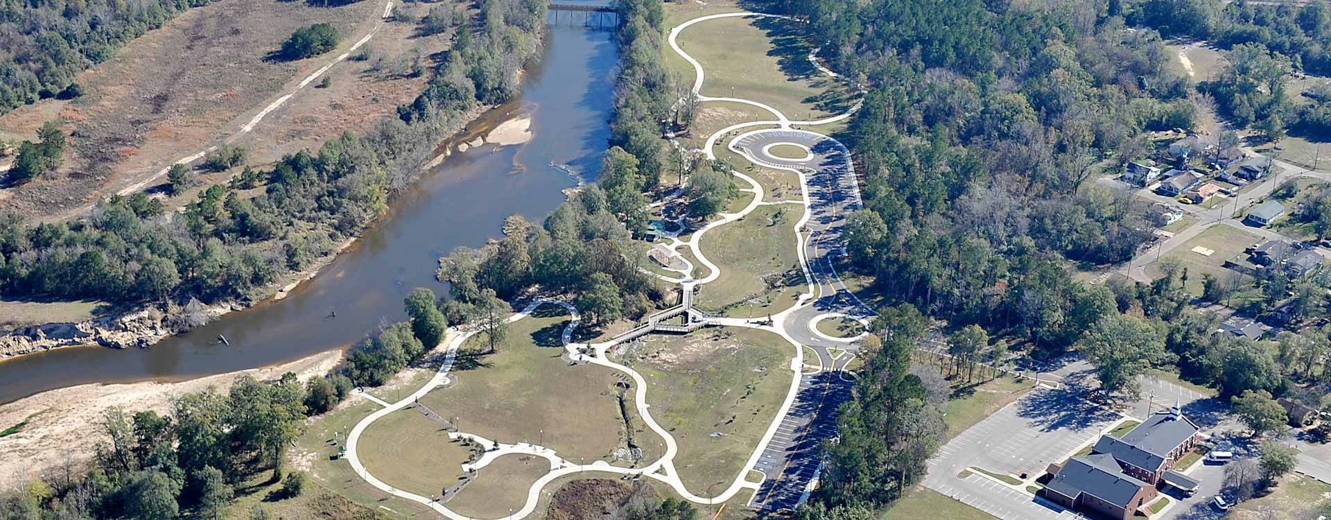 An aerial view of the park. It's an open grassy area with concrete walkways throughout.
