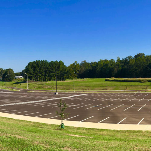 A view of the Alcorn State football stadium parking lot. It's surrounded by flat, grassy terrain.