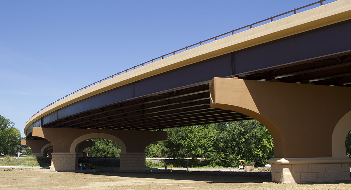 A bridge over a dirt area that's still under construction.