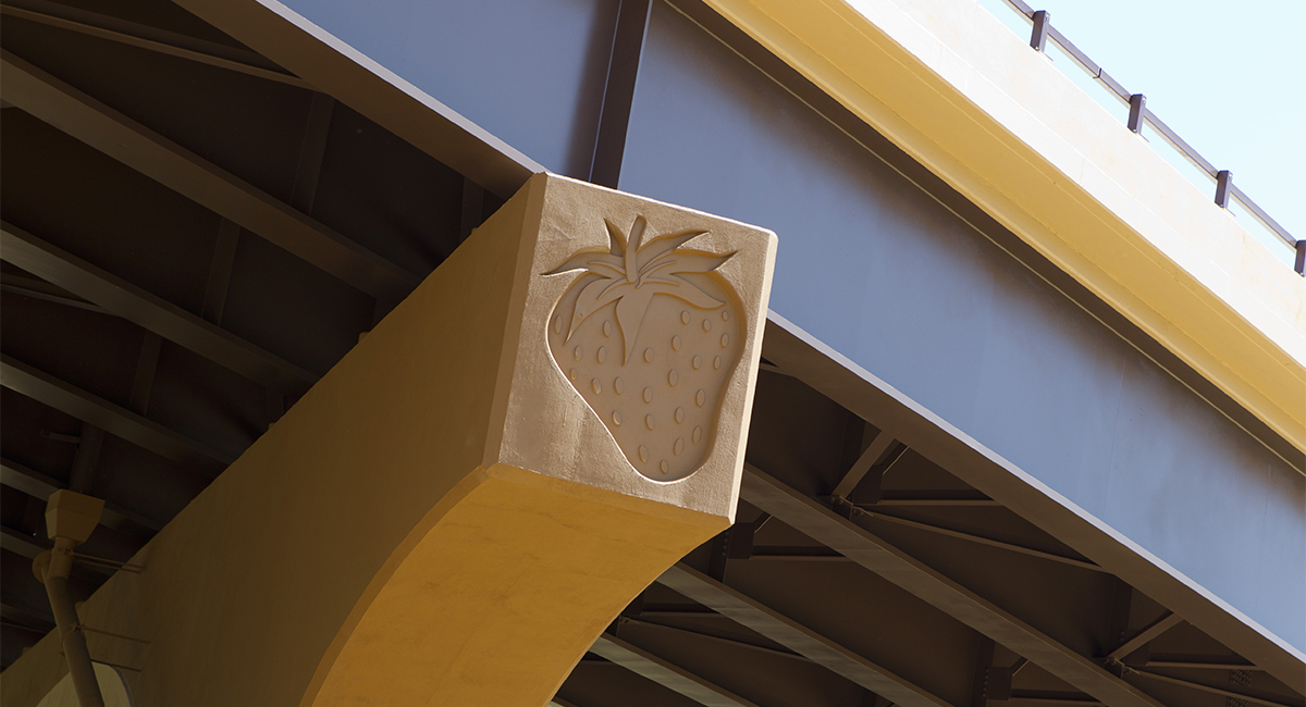 A strawberry carved into a column of a bridge.