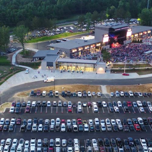 An aerial view of the Brandon Amphitheater that shows both the parking lot and the full amphitheater which descends into the ground.