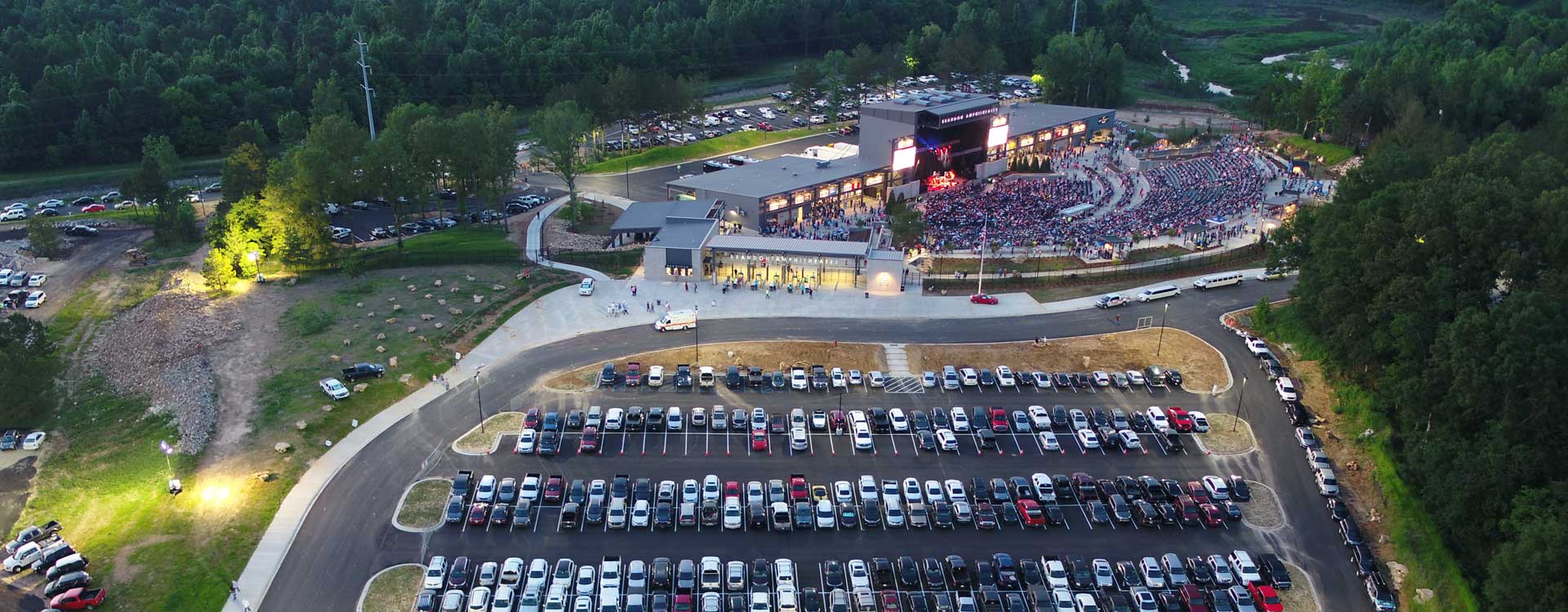 An aerial view of the Brandon Amphitheater that shows both the parking lot and the full amphitheater which descends into the ground.