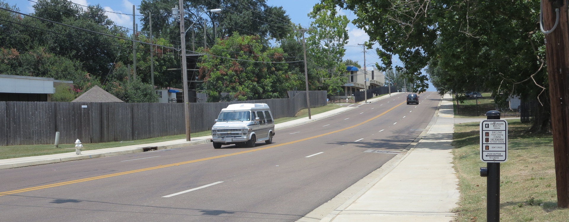 View of a car driving on a freshly paved Jackson street.